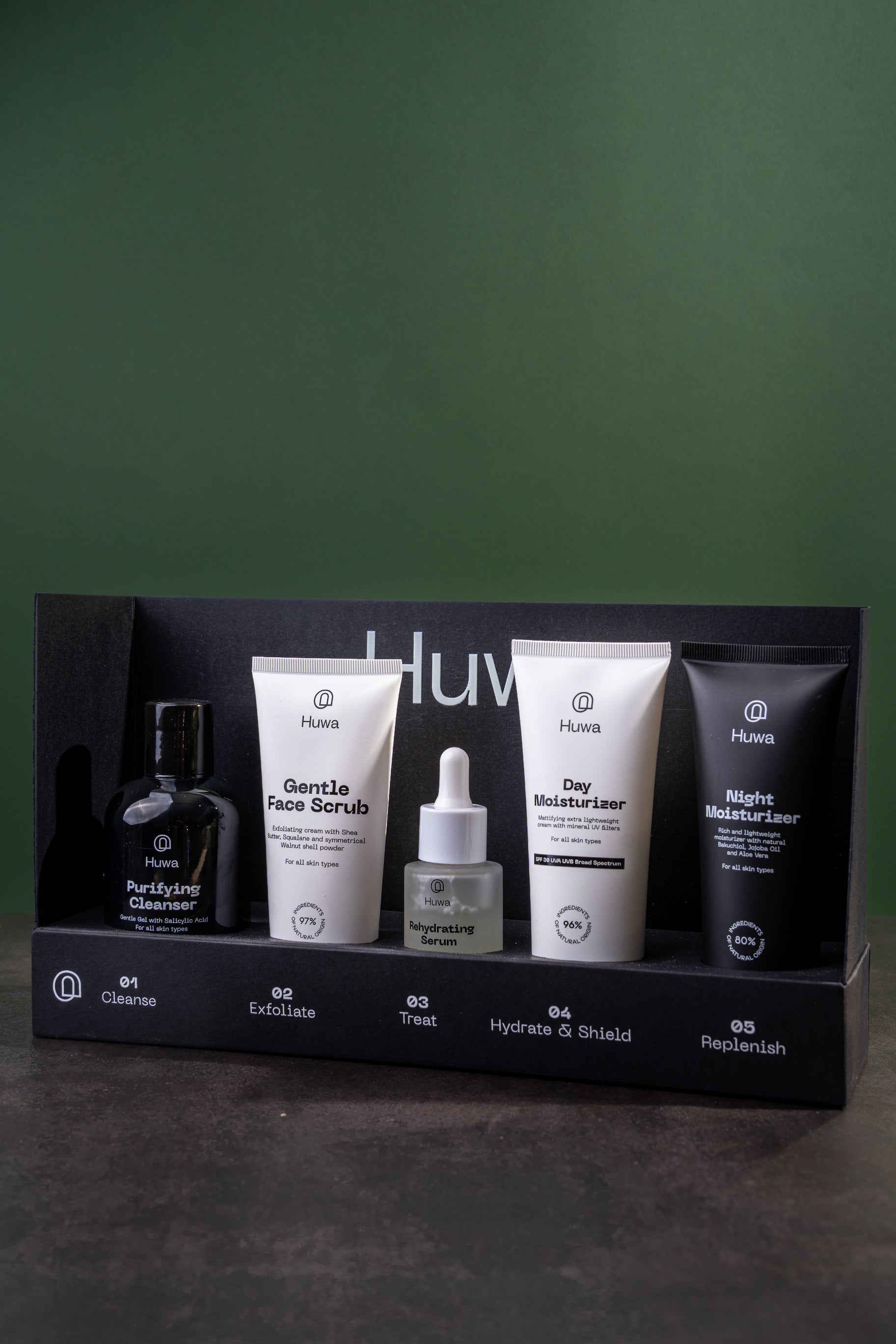 HUWA Bundle Set of 5 skincare for men, in a black box and a green wall