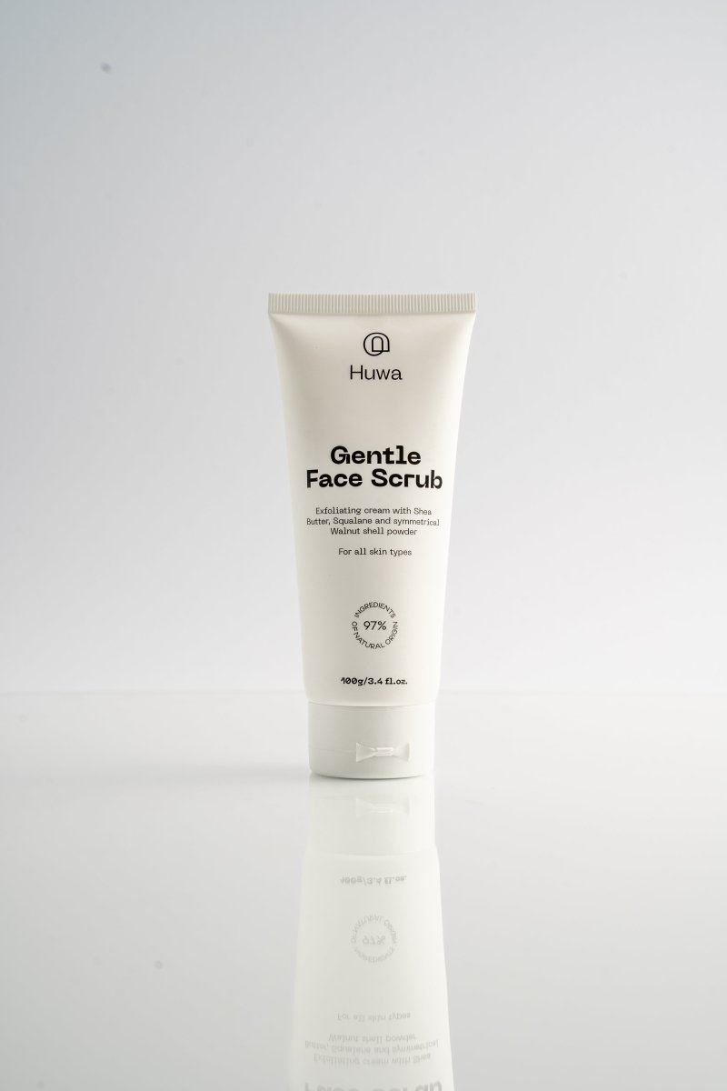 Huwa Skincare Gentle Face Scrub tube on a white background with a reflection under it front view