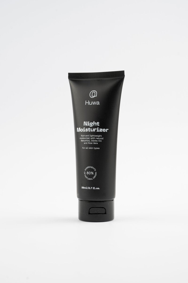 Black tube of Huwa Night Moisturizer on a white background with bakuchiol and jojoba oil