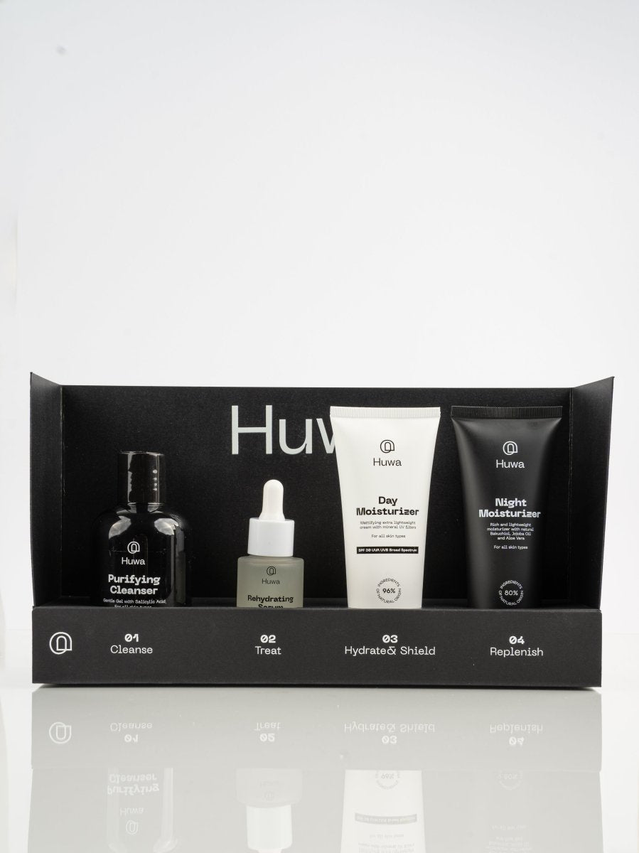 Set of skincare products including  a cleanser and day moisturizer and night moisturizer and a serum in a black bundle box sold together for a discount